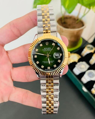 Rolex Datejust with a green diamond dial, gold fluted bezel, and a two-tone (gold & stainless steel) Jubilee bracelet.